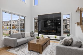 Spacious living room in the Aria 2 model, showcasing an open-concept layout with modern finishes