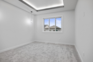 Spacious primary bedroom with walk-in closet and ensuite by Vita Homes