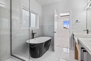 Luxury ensuite with a black free standing tub in Aria 2 by Vita Homes