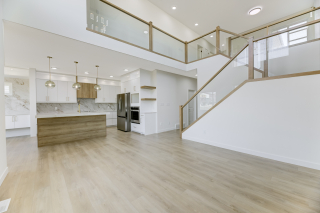 Modern open-concept kitchen and living space in the Aria model by Vita Homes, a custom home builder in Edmonton and Beaumont