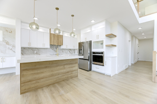 Modern designer kitchen in the Aria model by Vita Homes featuring quartz countertops, high-end appliances, and custom cabinetry