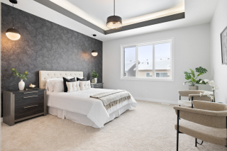 Bright and spacious bedroom with custom accent wall in the Bellagio model home - crafted by Edmonton and beaumont custom home experts