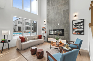 Spacious living room featuring a 20-foot high feature wall with an electric fireplace in the bellagio with Bar home desin