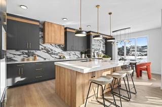 Open-Concept kitchen with end-to-end countertops and integrated bar area in the bellagio with bar floor plan