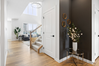 Bright and welcoming entryway in the Bellagio model by Vita Homes, featuring modern staircase and open-concept living — expertly built in Edmonton and Beaumont by trusted custom home builders