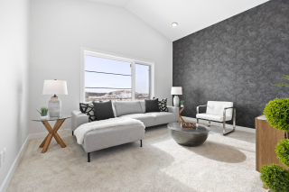 Sytlish upper-floor bonus room with textured feature wall, large windows, and contemporary furniture in a Vita Homes build — available in Edmonton and Beaumont