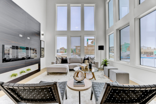 Spacious living room in the mirage model, featuring an open-concept layout with lots of oversized windows