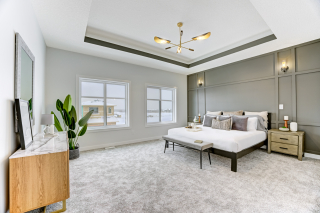 Master bedroom in the mirage model, featuring two large windows