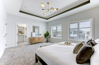 Master bedroom in the mirage model, featuring large windows and a walk-in closet