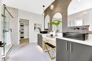 Modern ensuite bathroom in the Venetian model by Vita Homes featuring double vanity, arched mirrors, glass shower, and black vessel sink - Edmonton, Leduc and Beaumont