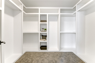 Spacious walk-in closet with built-in shelving in the Venetian model by Vita Homes - modern homes in Edmonton and Beaumont and Leduc