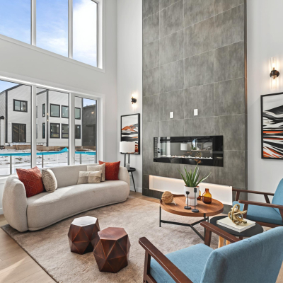 Spacious living room featuring a 20-foot high feature wall with an electric fireplace in the bellagio with Bar home desin